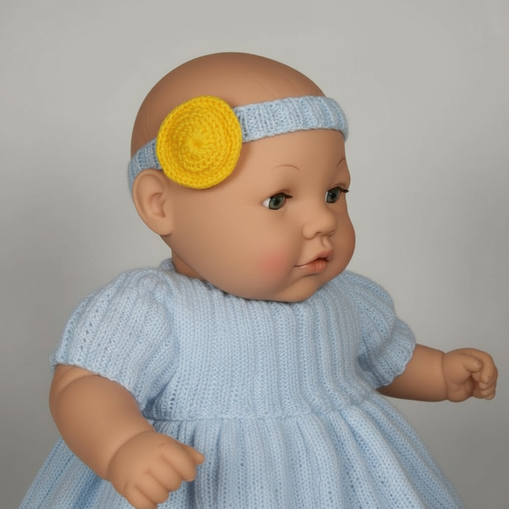 Baby doll wearing a white dress and purple headband on a gray background