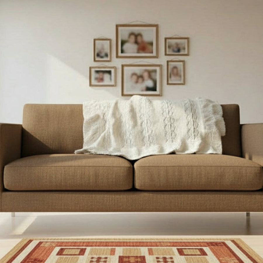 Brown sofa with a white blanket in a living room setting