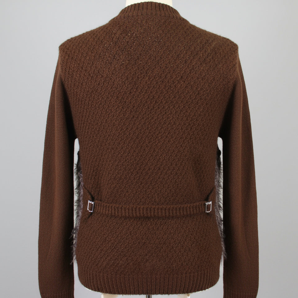Brown knitted sweater on a mannequin with a blurred background