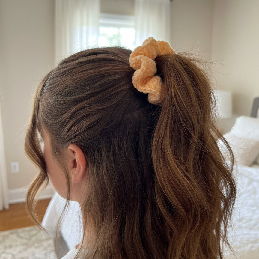 orange scrunchie in a girls hair